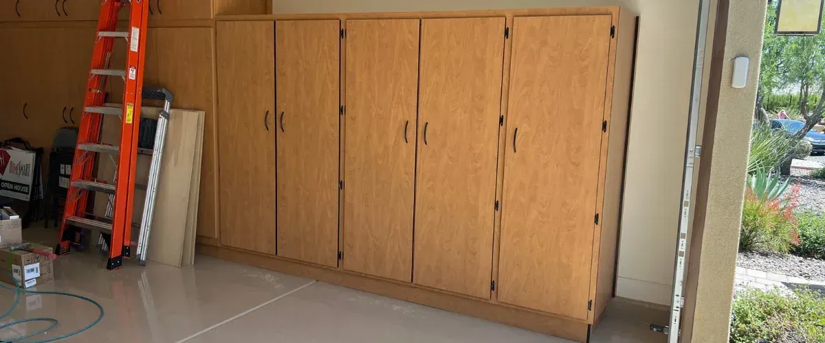 Custom garage cabinet system with workbench, pegboard wall, and multiple storage drawers