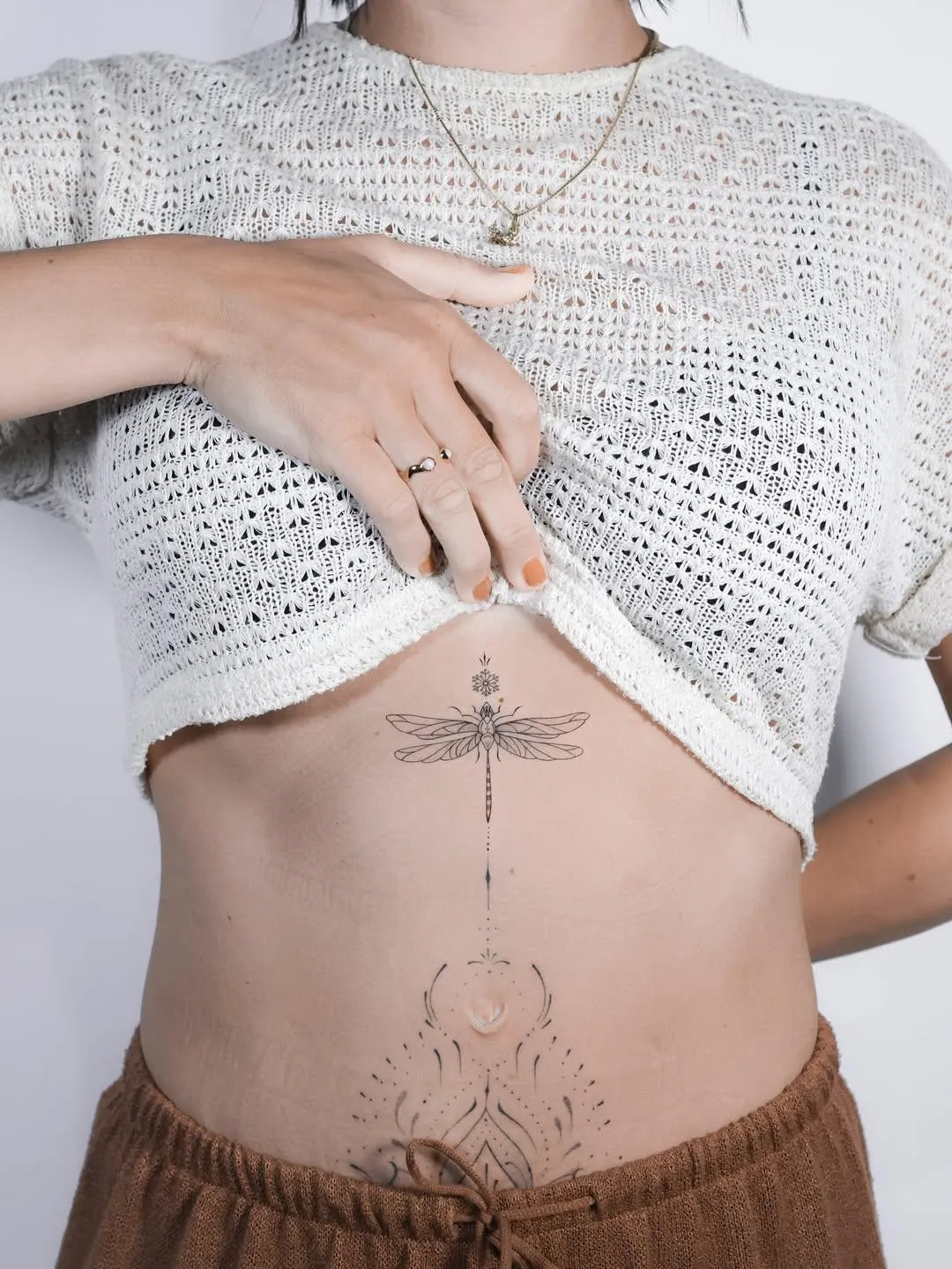 person in blue denim shorts and white nike sneakers standing on gray concrete floor