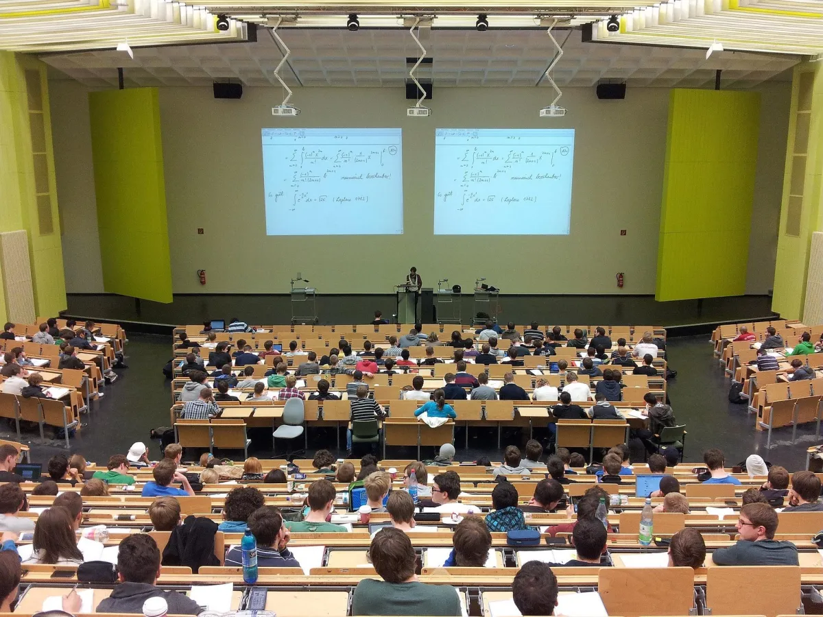 a large university lecture room with students and an instructor
