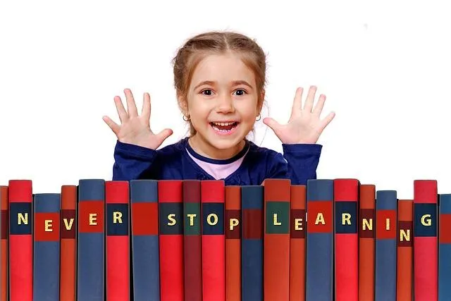 a girl next to a shelf of books that spell "never stop learning"