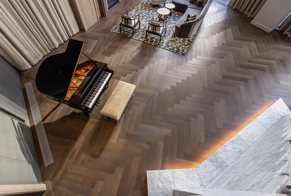 A lobby lounge with custom herringbone flooring