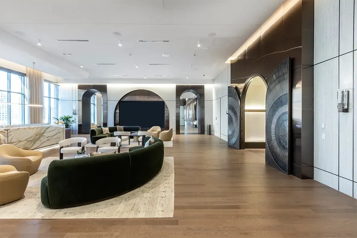 This photo shows a lobby and seating area with red oak wood flooring