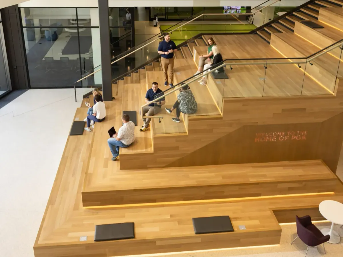 This photo shows the social seating space with wide commercial stair treads at PGA headquarters