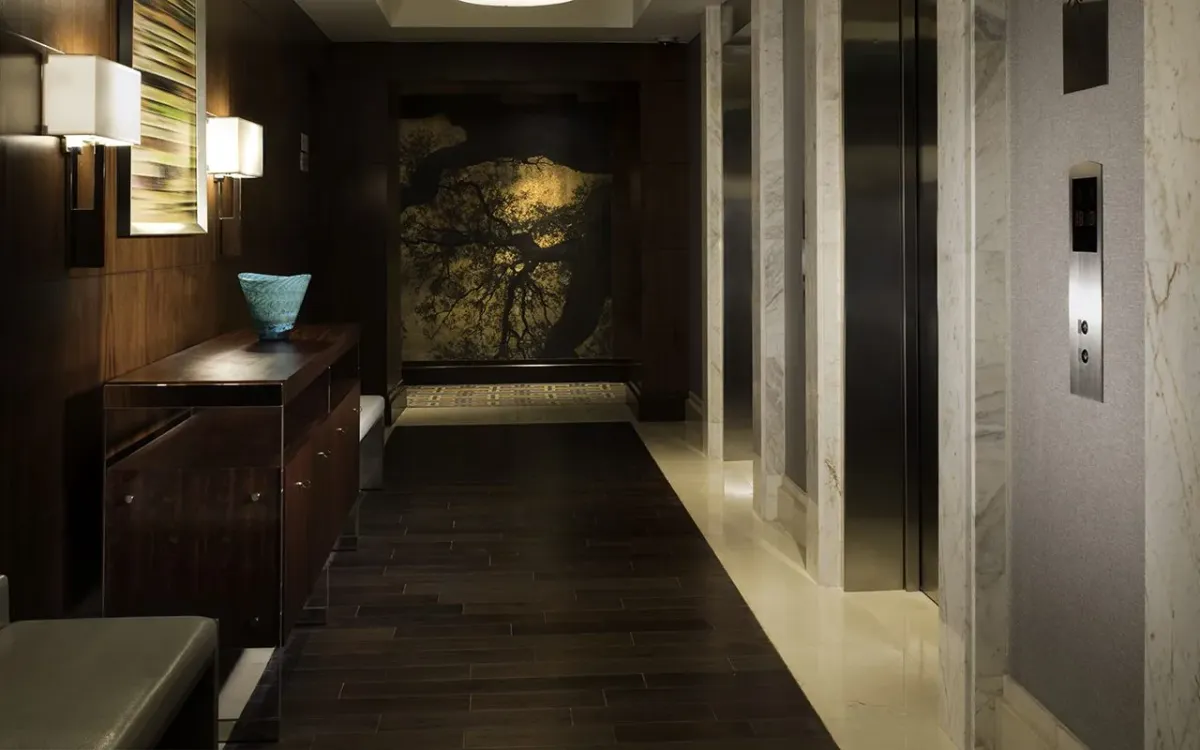 This photo features an elevator lobby that uses Mesquite flooring, one of the densest wood species