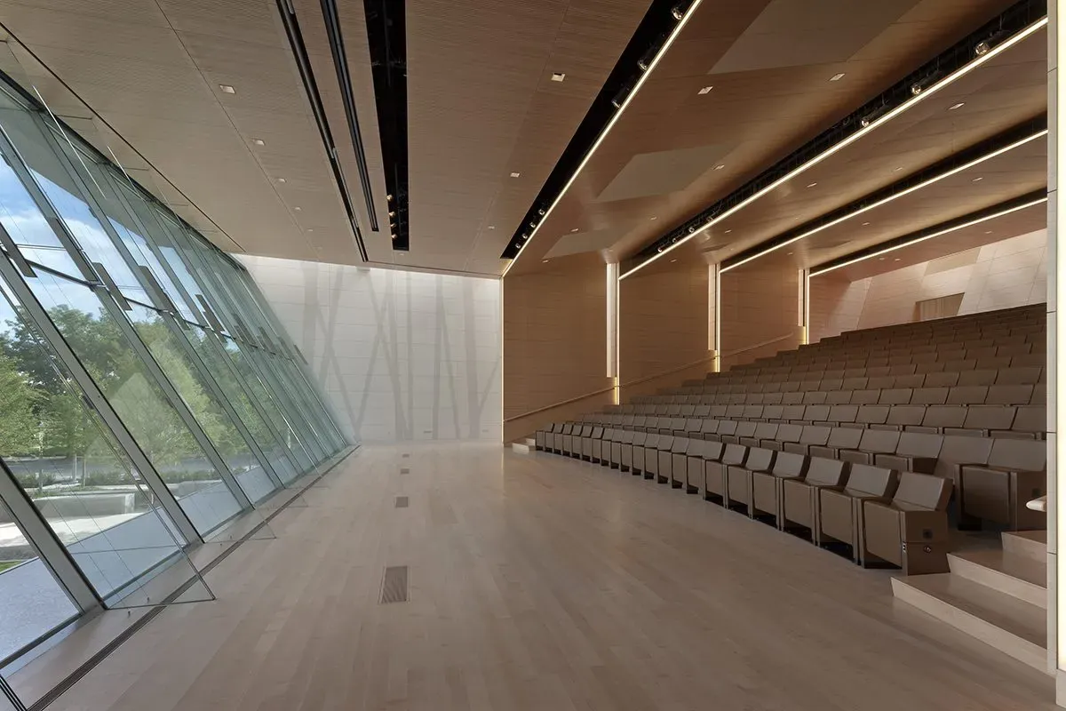 This photo features an auditorium with maple flooring and stair treads