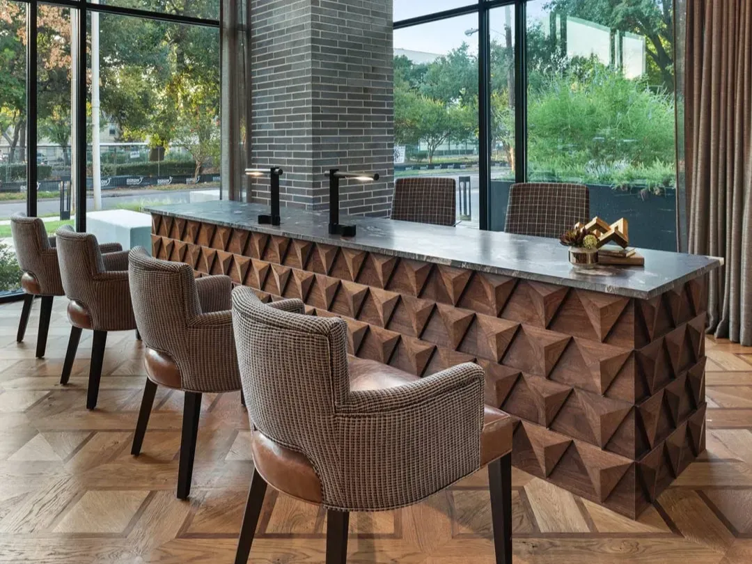 This photo features a reception desk with custom wood designs