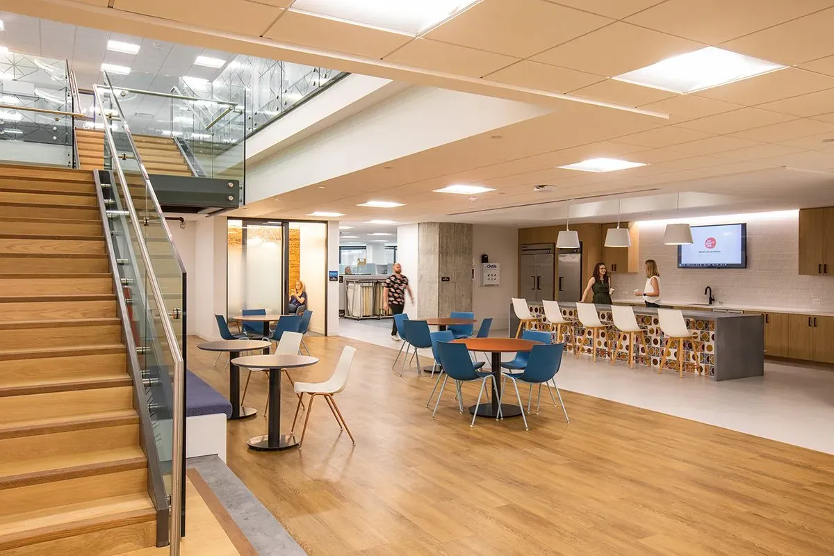 This photo features an office lounge that uses oak hardwood flooring and accents