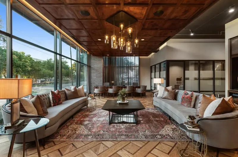 This photo features a stunning lobby lounge with custom cut wood flooring