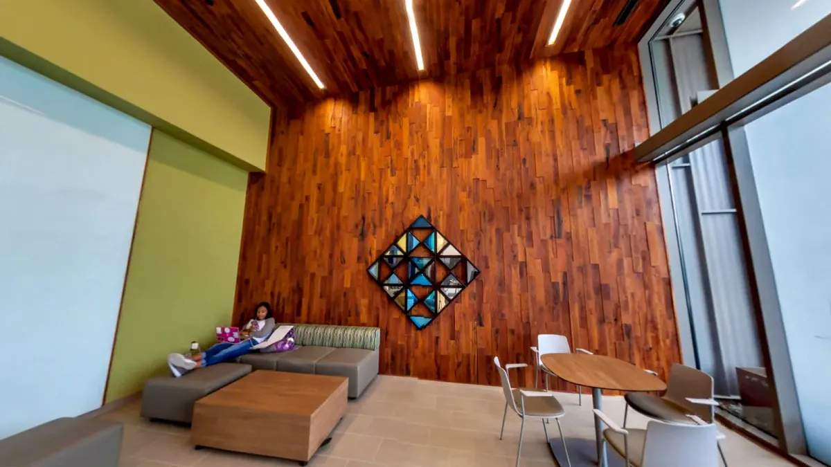 This photo shows a college lounge with a wood plank accent wall