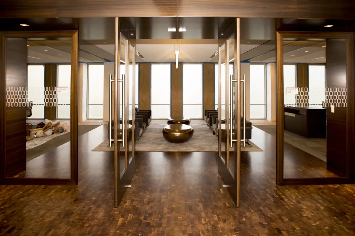 This photo shows a lobby that uses solid hardwood flooring to highlight their signature space