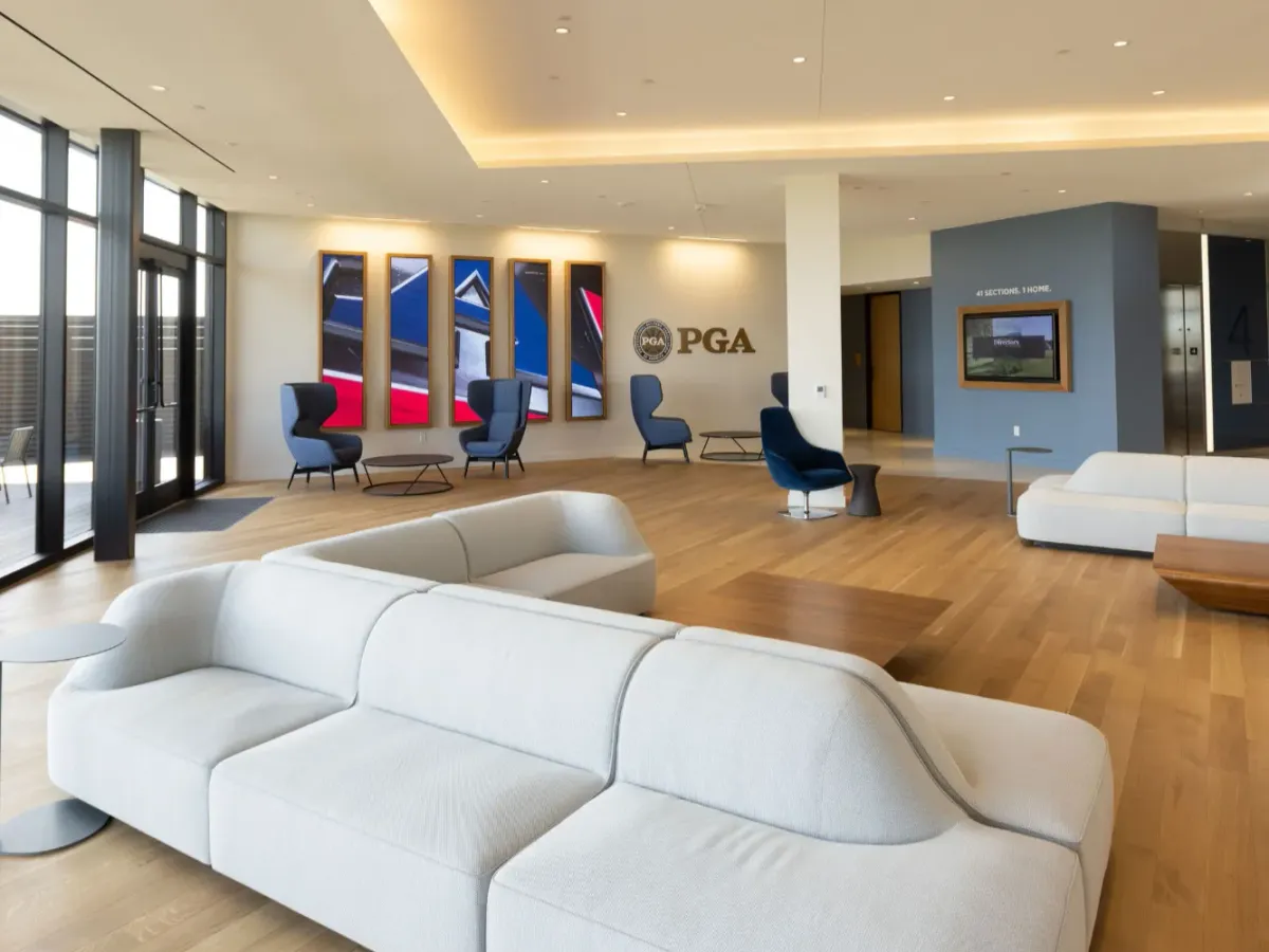 This is an image of a PGA office that's furnished with chairs, couches, and tables.