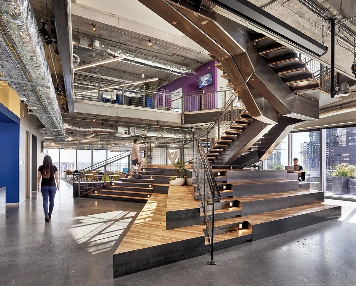 A photo of Atlassian's building that uses architectural wood flooring.