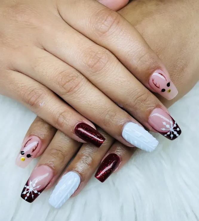 A close-up of a hand with intricate pastel floral nail art, gently holding a white teacup. The background is softly blurred, drawing attention to the detailed, artistic nail design and the delicate, feminine style.