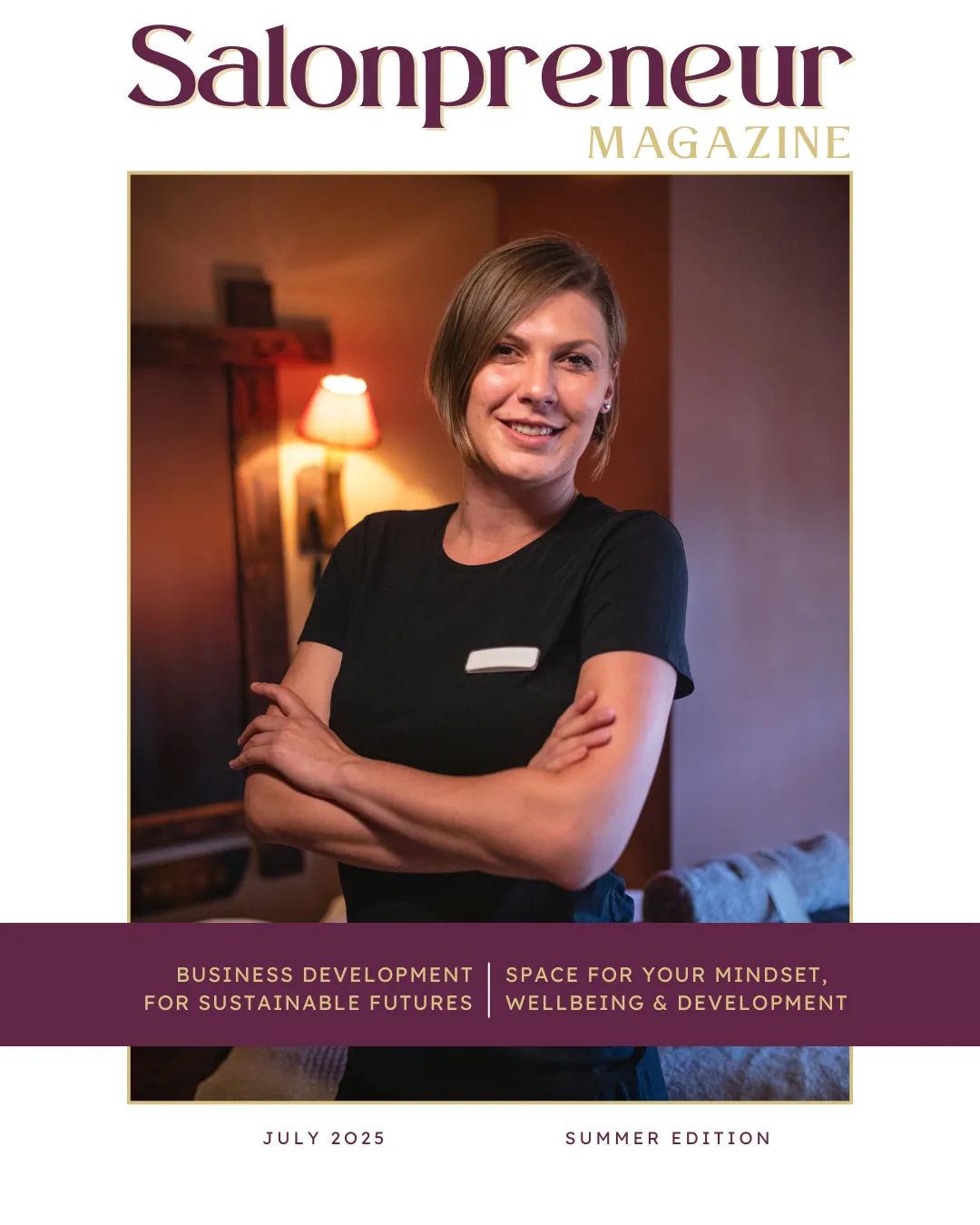 Salonpreneur Magazine mock cover, showing female salon owner in black t-shirt with arms folded facing camera smiling. Chin length brown hair and light make up. Backdrop with mirror wall light and massage couch. Mulberry colour band stating "business development for sustainable future" and "space for your mindet, wellbeing & development. For more information please visit www.salonpreneurmagazine.co.uk