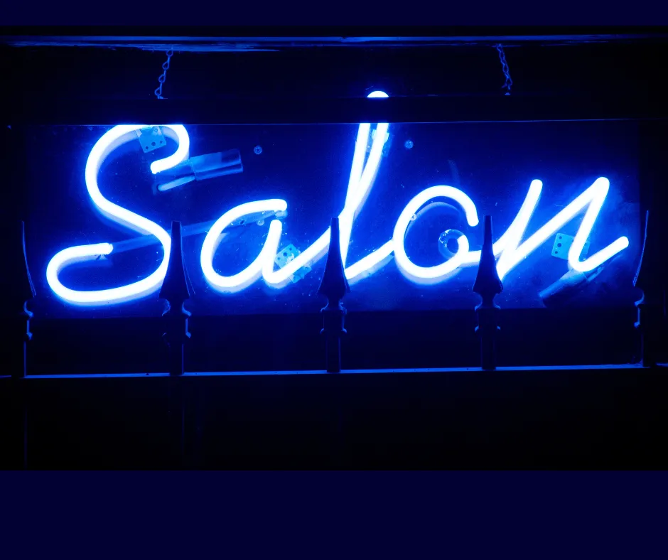 Neon light with blue italic writing saying Salon on a dark background Salonpreneur Magazine the UK publication for salon & wellness sector business owners