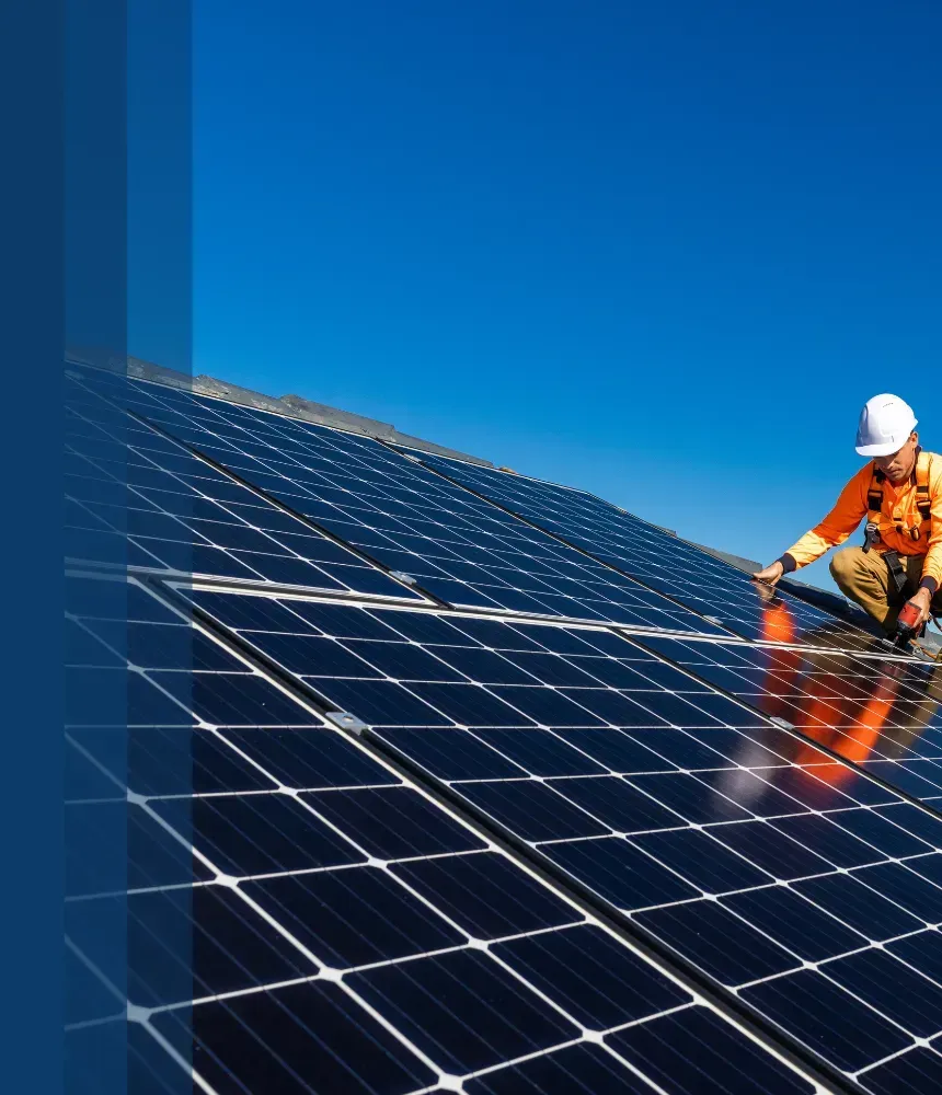 A technician in safety gear performing solar panel cleaning on a rooftop under a bright blue sky to keep panels efficient. Service by Brian.