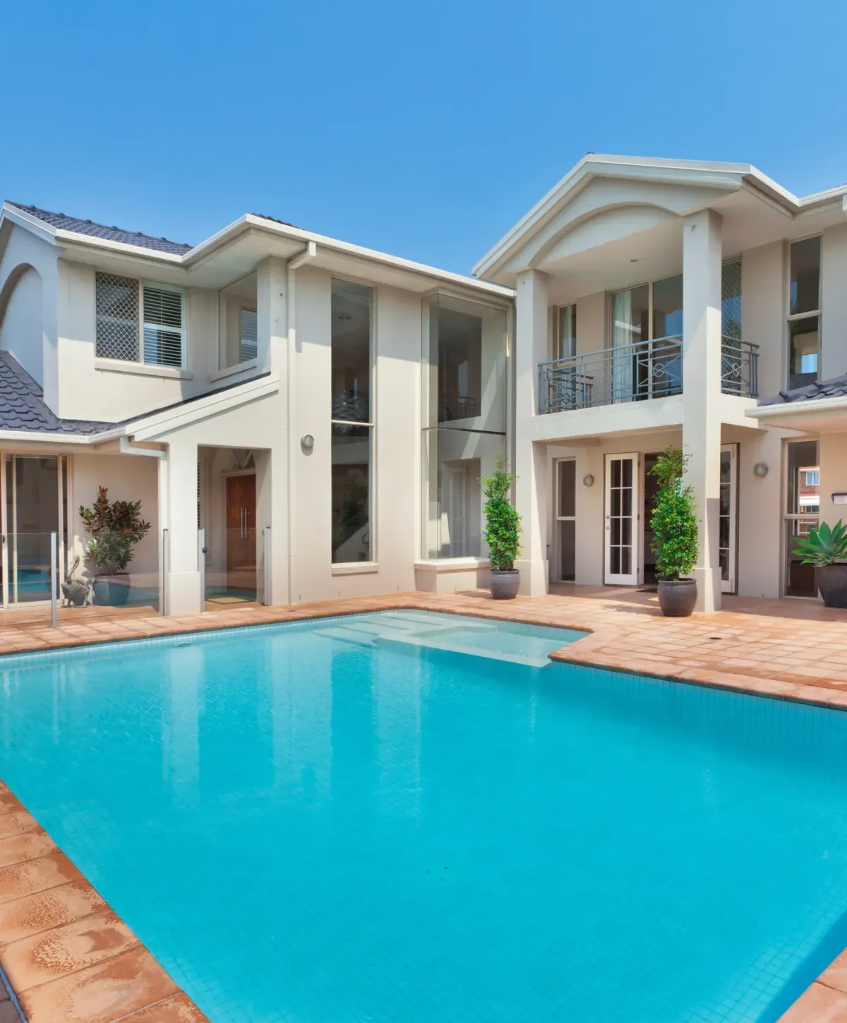 Modern home with a large swimming pool and outdoor patio area