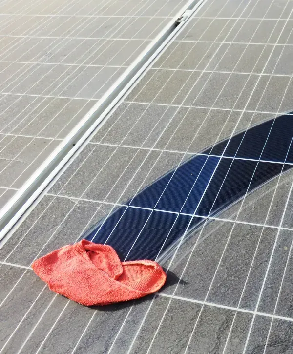 solar panel being cleaned with a microfiber cloth