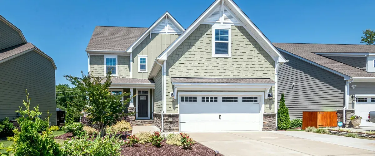 Modern suburban two-story home with clean driveway and landscaped yard