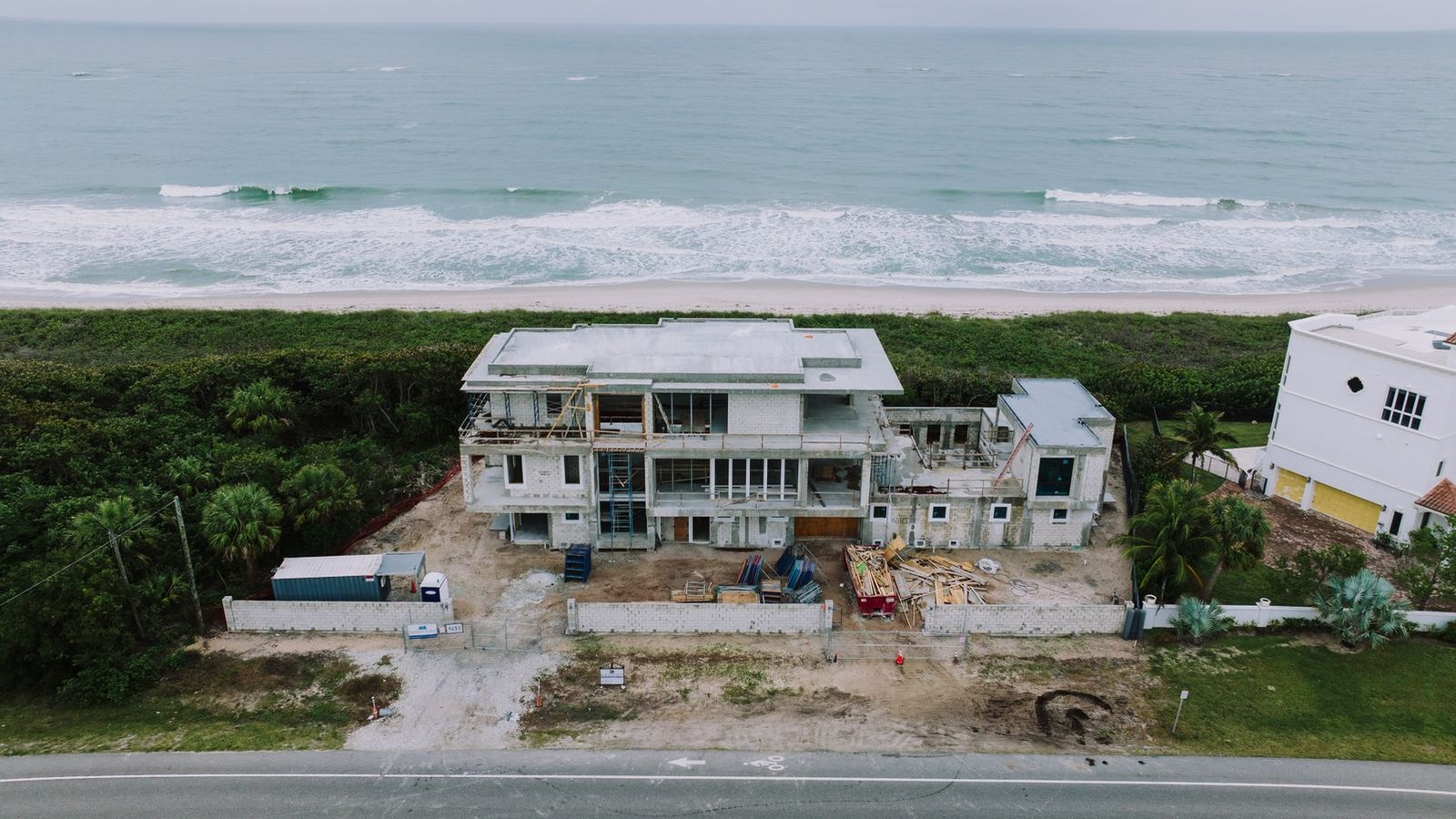 Aerial view of a new coastal Southwest Florida home under construction on its lot