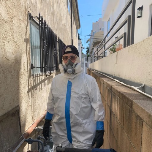 PDRS team member in cleaning suit to provider Flood cleanup emergency services