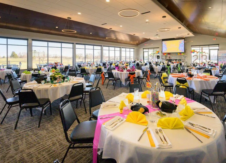 Smiling senior man holding mug and phone on couch.