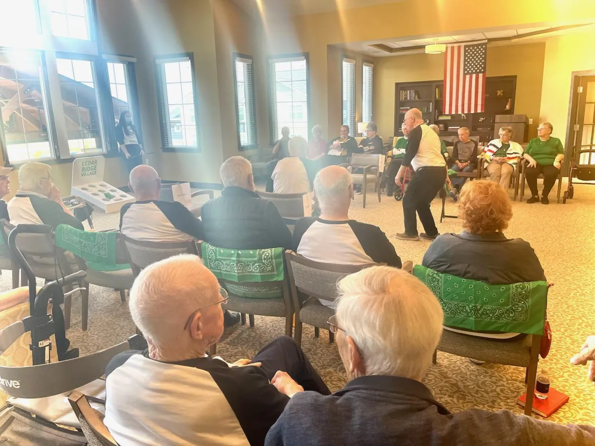 Sunset over a lake with trees and gazebos.
