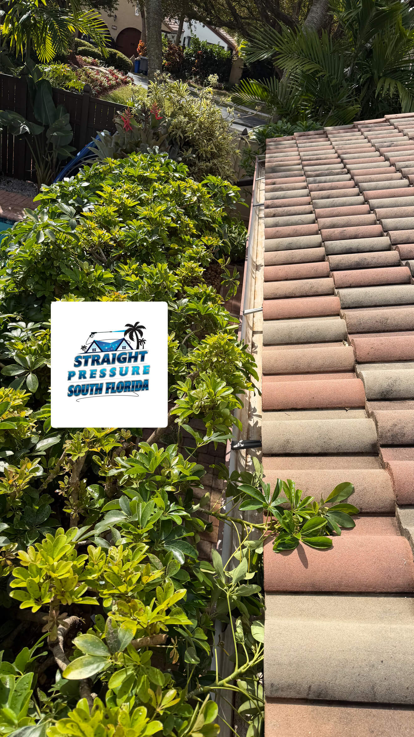 Detailed view of a pristine, clear gutter following a professional gutter cleaning service in Boca Raton, FL, with the clean tile roofline visible in the background.