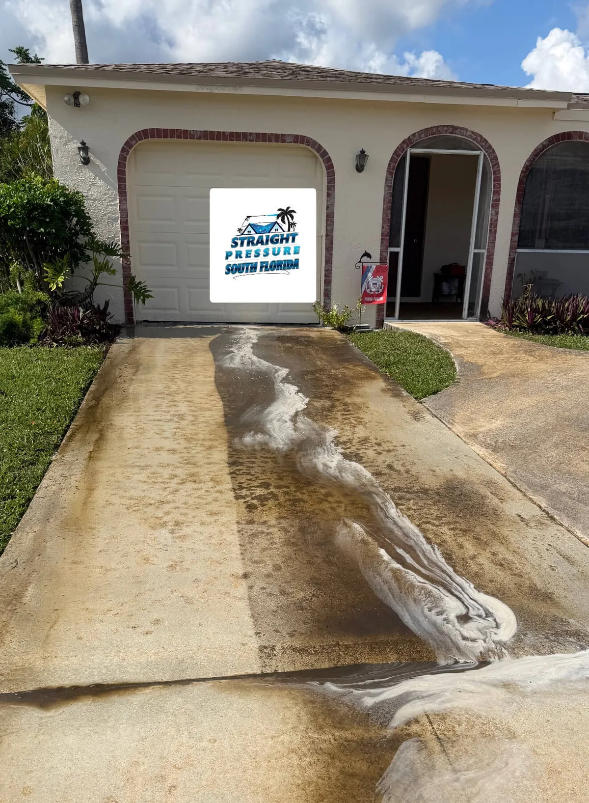 Concrete pressure washing in Boca Raton FL, removing dirt from driveway.