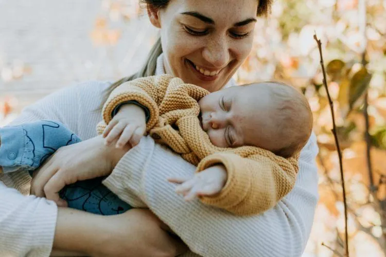 mother holding newborn baby representing spirit baby reading experience and emotional connection to motherhood