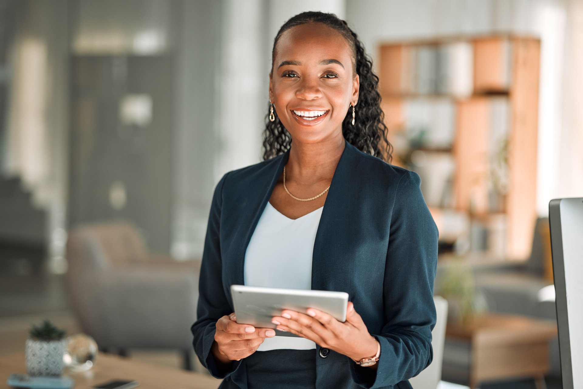 A clean, modern 3:2 image of a friendly customer service representative, early 40s, speaking on a headset in a bright, open office. The background features soft blue and white tones, with subtle branding elements and a welcoming atmosphere.