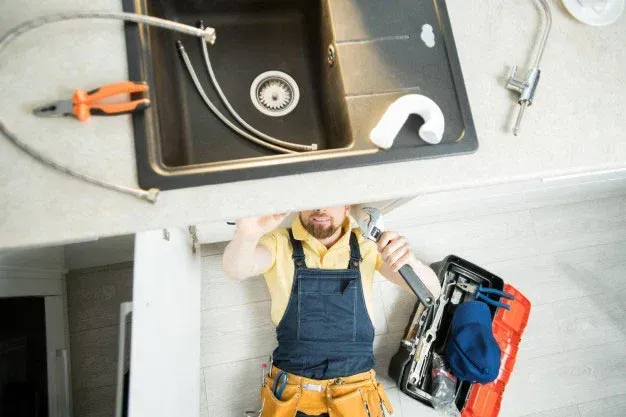Tech hydro-jetting a grease-clogged restaurant drain in Hoover.