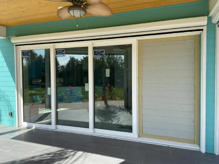 Retractable screen for sliding glass doors with seamless, low-profile track