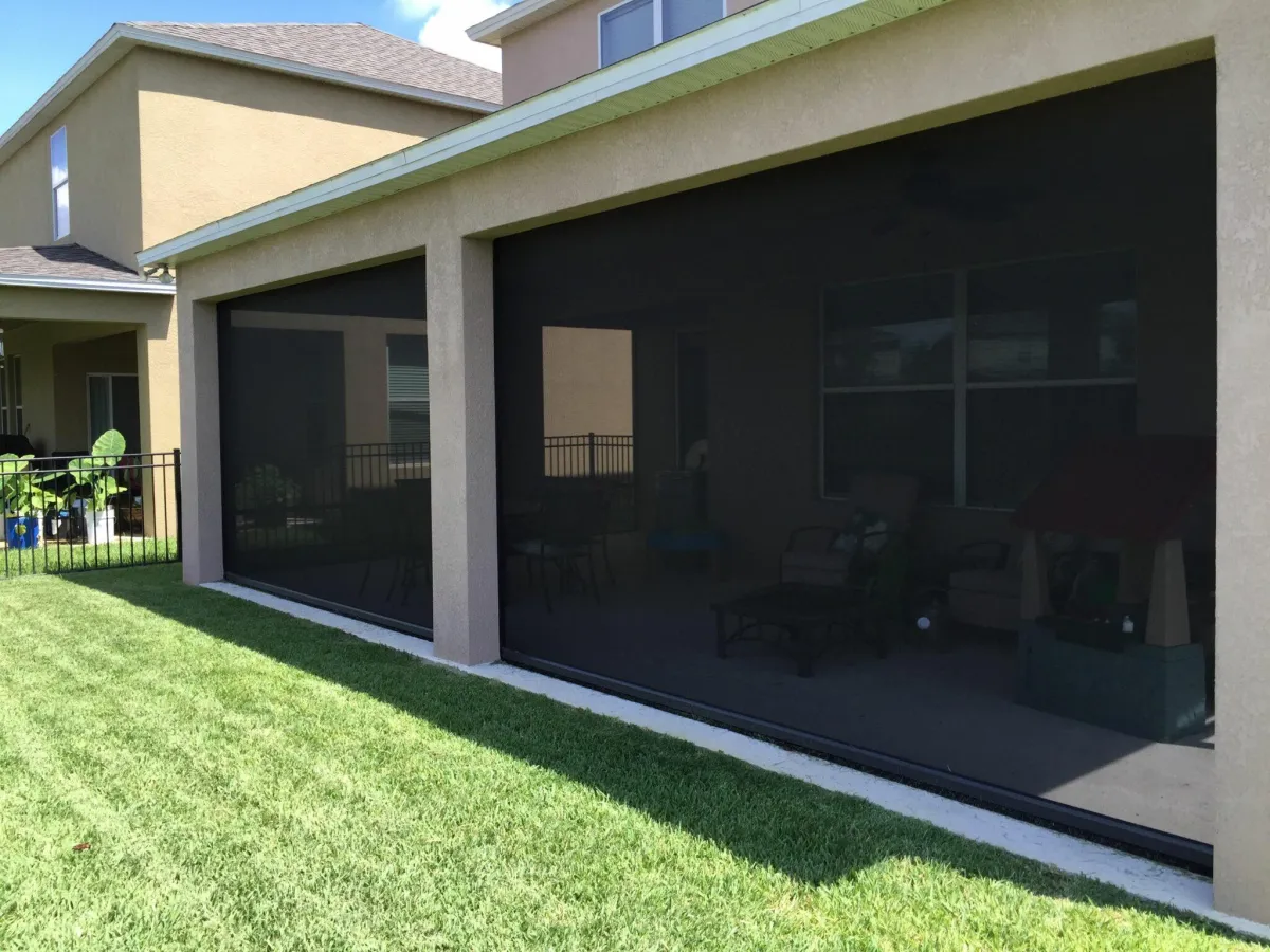 Housed retractable screen unit installed on a residential exterior providing shade and airflow