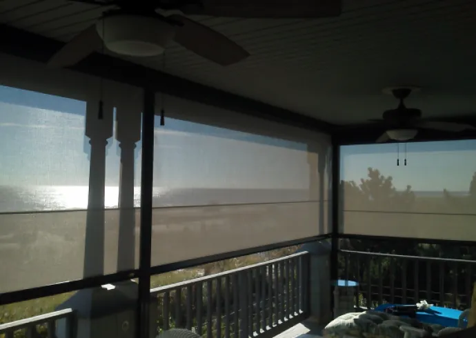 Hurricane-rated screen lowered for storm protection on patio opening