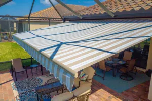 Compact awning system over sliding door for controlled sun exposure
