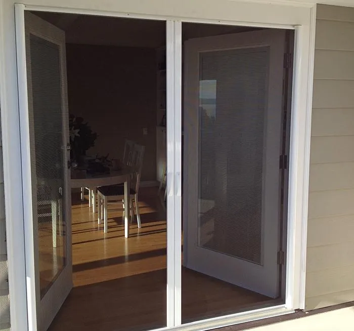 Double Retractaview screens meeting in the center for wide patio opening