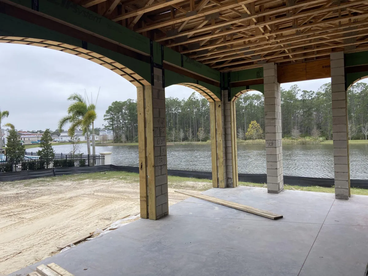 Framing process underway for retractable screen system on residential property with focus on material options