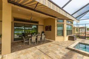 Motorized awning providing shade over poolside seating area