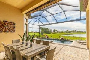Modern motorized awning covering backyard deck during sunset