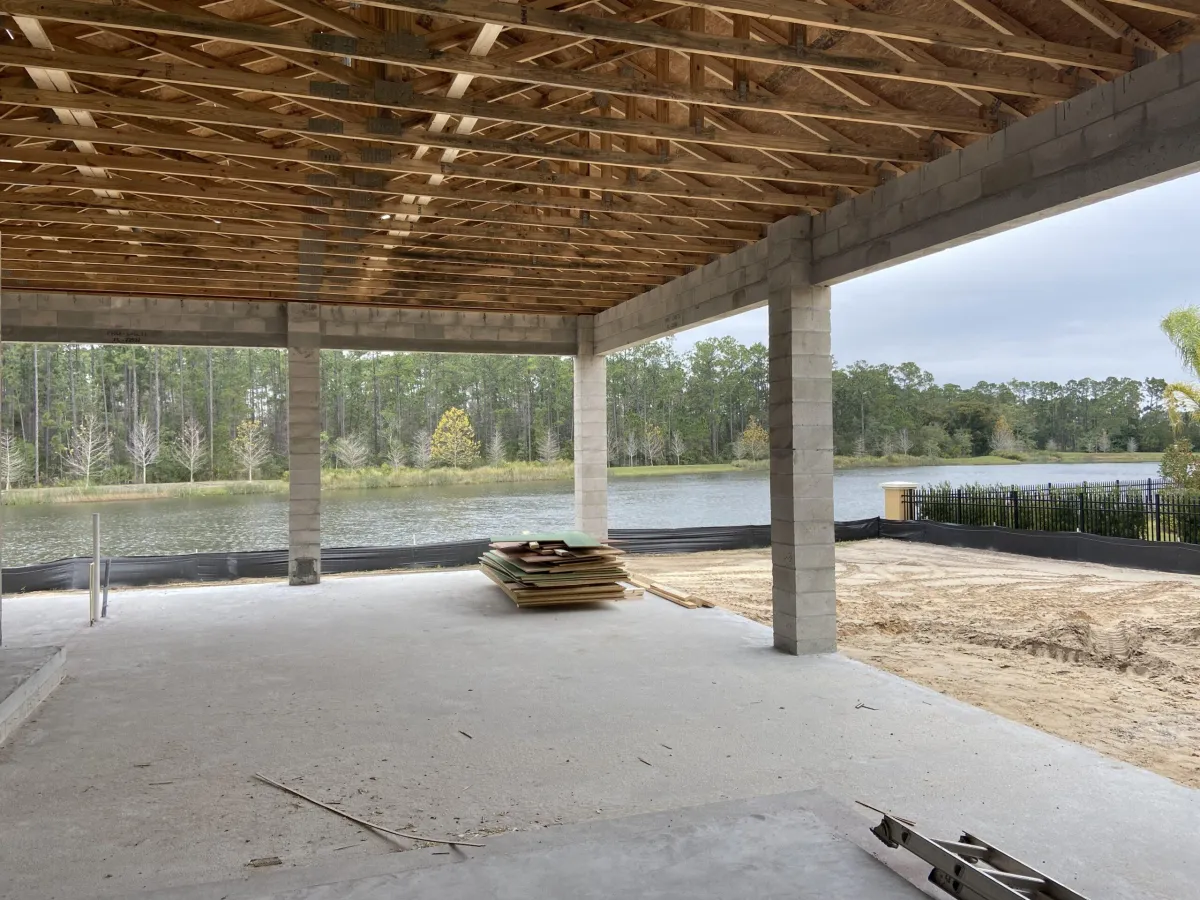 Framing process underway for retractable screen system on residential property with documentation and site review