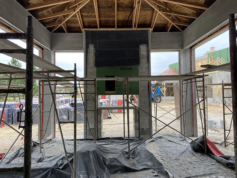 Technician installing recessed tracks and mounting brackets for seamless screen integration during the initial walkthrough