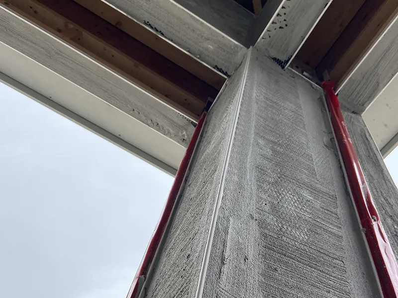 Technician installing recessed tracks and mounting brackets for seamless screen integration with documentation and site review