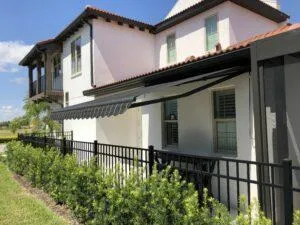 Slim-profile awning blending with exterior color palette