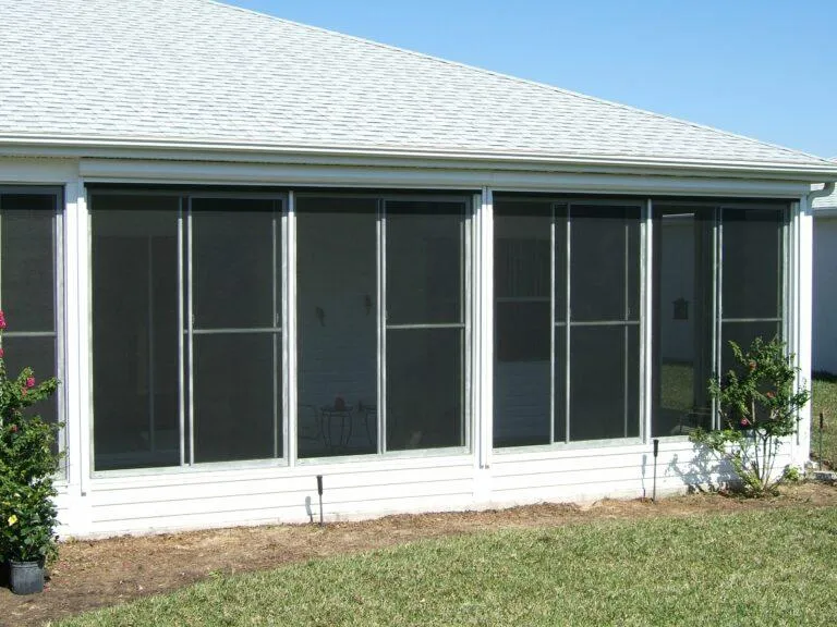 Motorized shade system covering the exterior of a sunroom for UV control
