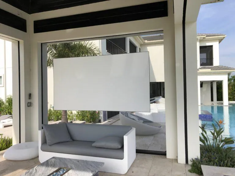 Dual-sided retractable movie screen extended for backyard cinema night