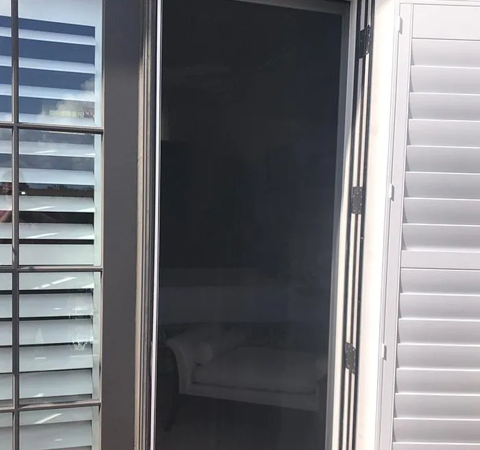 Manual double VistaView screen in action on patio entrance