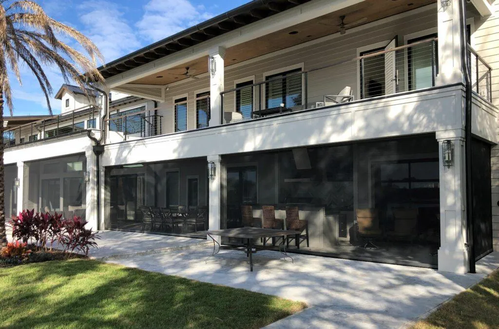 Retractable screen fully extended across a patio opening, providing shade and insect protection