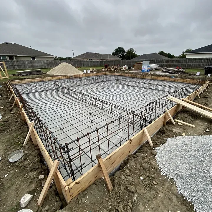 Rebar grid laid inside wooden formwork for a residential concrete foundation in Marrero Louisiana