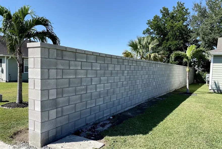Finished concrete block privacy wall along a property boundary